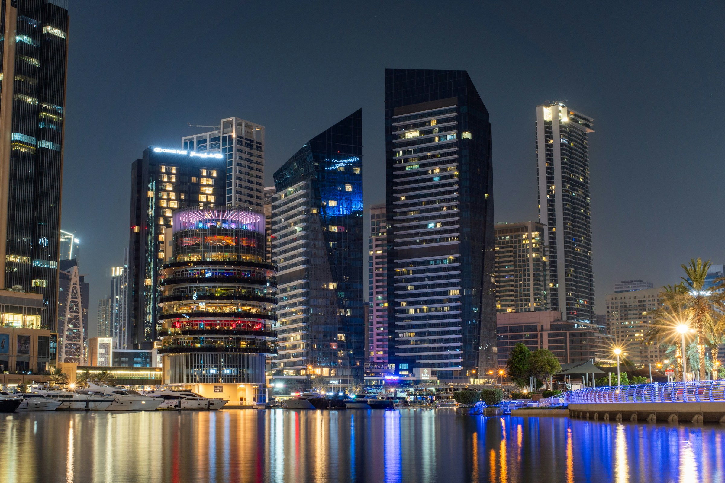 Dubai: illuminated skyline and waterfront at night.