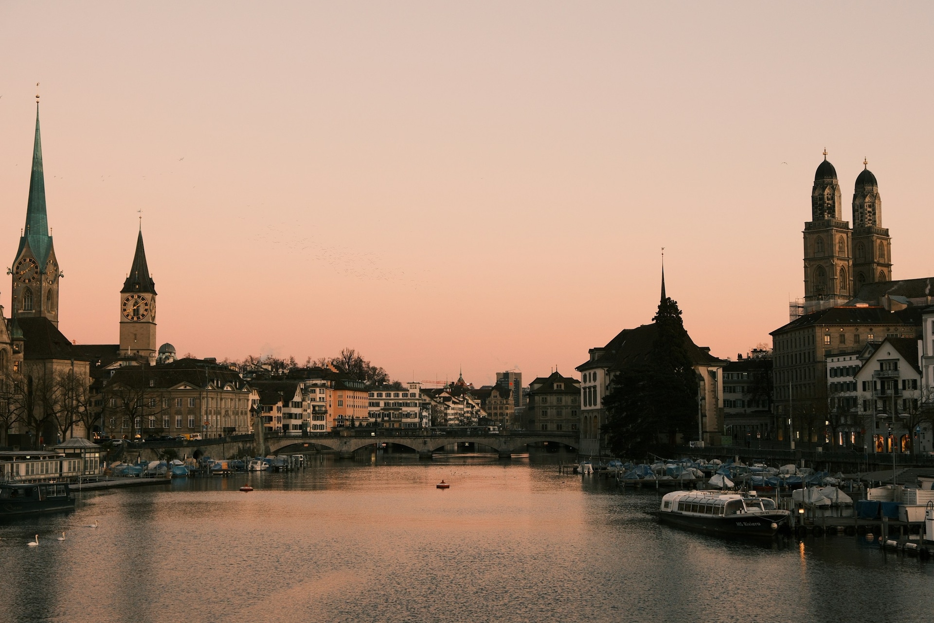 Zurich old town and Limmat at dusk—illustrative of our Swiss programmes.